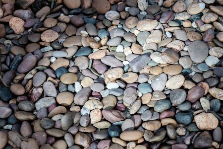 Stone texture background, Stone ordering in the garden floor, Stone in various colors. Stone with sunlight exposure in the middleの写真素材