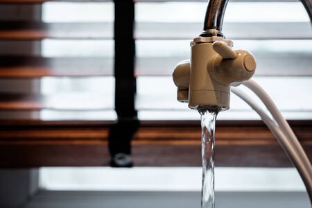 A white plastic water faucet without any water flow from itの写真素材