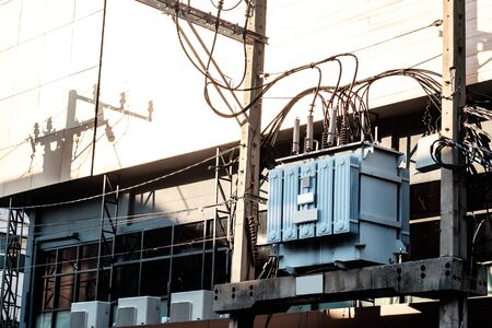 High voltage AC power transformer, connected with wires and cables, maintaining a stable voltage inside the city and metro areaの写真素材