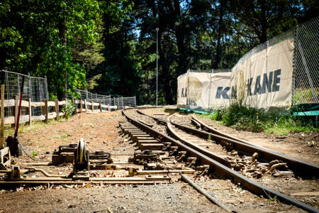 A rusty traditional railway merging together with mechanism on a sandy area in the Melbourne,...
