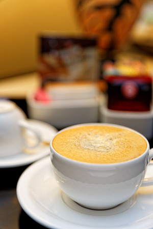 Coffee Cup as is usually offered in Hotel Rooms Cup in the foreground with selective focus in the middle of the cup の写真素材