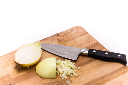 Chopped onion with knife on a wooden board