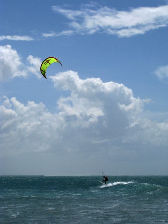 Young brazilian kitesurfer riding and jumping the waves of Jericoacoara beach, north-eastern Brazil.の写真素材