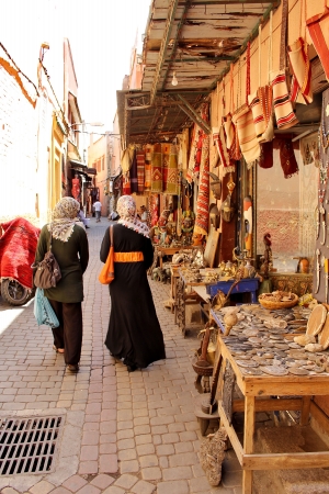 Moroccan women in the colorful streets of the main souk of Marrakesh, Moroccoのeditorial素材