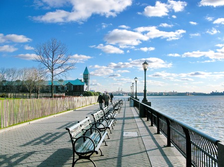 New York City  Battery Park sidewalk on a sunny day, with historic Pier A on the back の写真素材