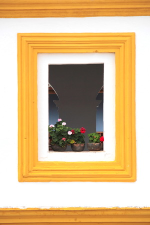 Antigua, Guatemala: beautiful window with flowers in the old streets of Antigua, the former colonial capital of the country.の写真素材
