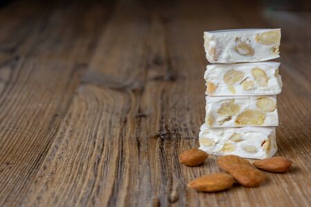 pieces of nougat on top of each other on a wooden backgroundの写真素材
