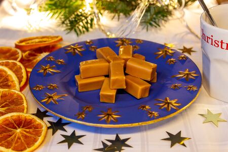 cream toffee candies, orange slices and starsの写真素材