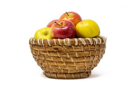 basket of red and yellow apples isolated on white backgroundの写真素材