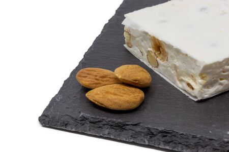 almond nougat on slate and white background