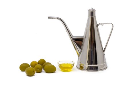 small bowl with olive oil and green olives on a white backgroundの写真素材