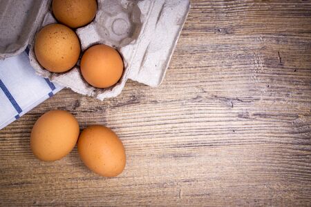 eggs with carton box on wooden tableの写真素材
