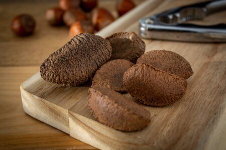 brazil nuts on wooden cutting board