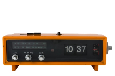 Vintage orange radio clock on white background