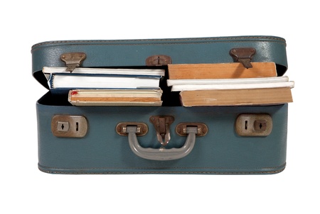 Leather suitcase filled with books on white backgroundの写真素材