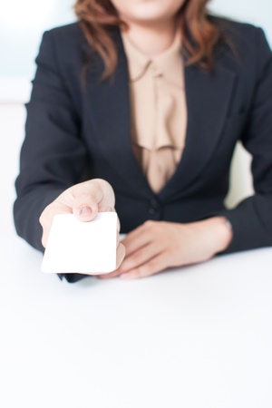 Portrait of young businesswoman holding blank white business cardの写真素材