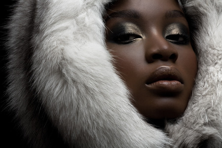 Beautiful dark model wearing polar fox hat.の写真素材