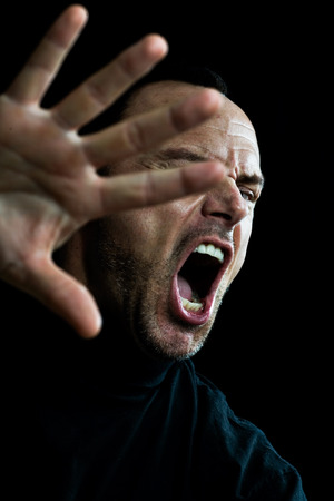 Screaming man in black.の写真素材