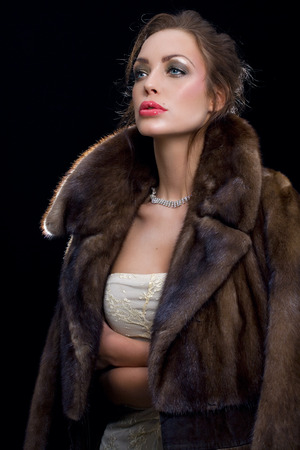 Woman wearing jewelry and mink coat.の写真素材