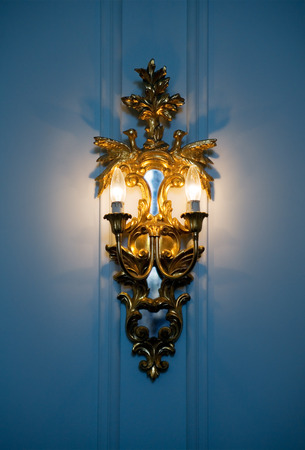 Rococo-style wall bronze lighting fixture with electrical light.の写真素材