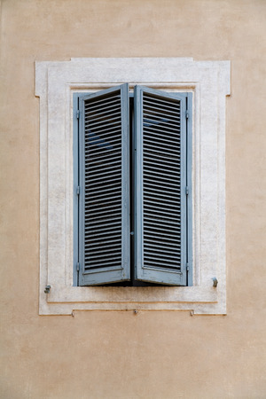 Old closed window with blinds in Rome.の写真素材