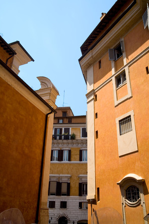 Orange houses against blue sky on street of Rome.の写真素材