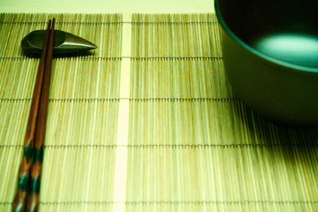 Japanese traditional wooden plate and chopsticks over tatami.の写真素材