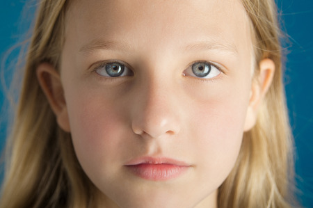 Dreamy intense closeup portrait of a beautiful ten year old girl.の写真素材