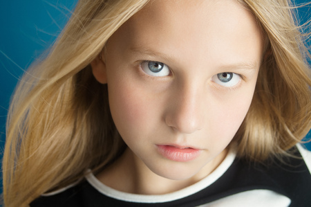 Dreamy portrait of a beautiful ten year old girl with long hair.の写真素材