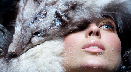 Model dressed in fur. Focus is sharper on animal head.の写真素材