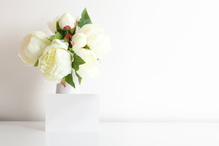 Beautiful peonies and empty greeting card for text.の写真素材