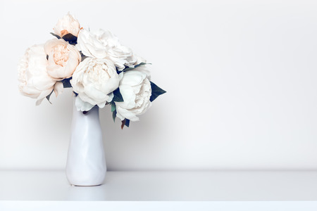 Beautiful peonies bouquet in minimalist indoor setting.の写真素材