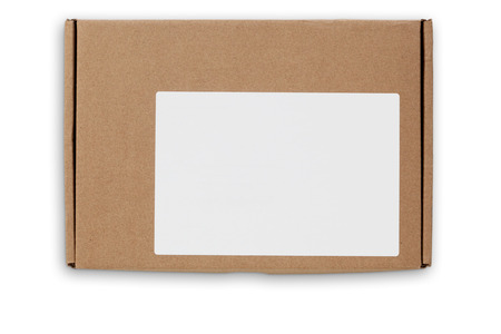 Top view of flat postal packaging box in craft paper with white empty lable. Object is isolated on white background and has soft shadow and clipping path.の写真素材