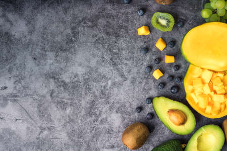 Still life of fruit, kiwi, blueberry, mango, avocado, blueberry and appleの写真素材