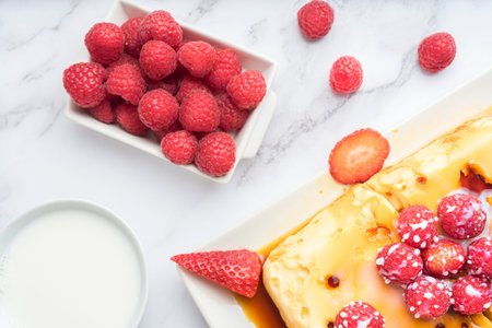 Condensed milk flan with raspberries and strawberries.