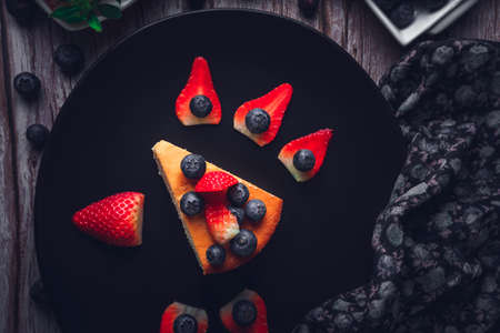 Cheesecake with blueberries and strawberries. Sweet dessert.の写真素材