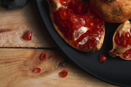 Still life of pomegranate a wooden background. Dark food concept