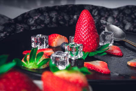 Still life of strawberry and blueberries. Dark food. Sweet dessert.の写真素材