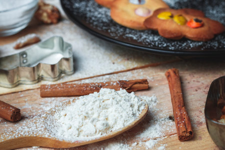 Still life making homemade cookies for Christmas with cookies, black plate, flour, egg, nuts,...