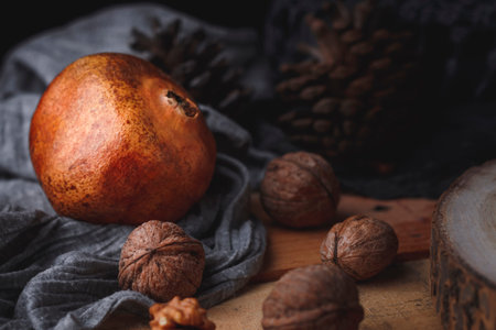 Still life of pomegranate a wooden background. Dark food concept. No people. Front view