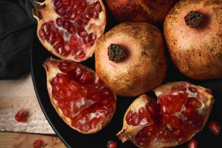 Still life of pomegranate a wooden background. Dark food conceptの写真素材