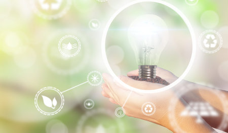 Women's hands holding a light bulb for ecology and renewable energies