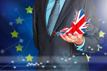 Businessman with British flag sinking on European flag representing the Brexit of United Kingdom with Europe. Political and business conceptの写真素材