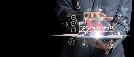 Businessman analyzing the sales market with virtual graphics holding a tablet.