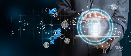 Businessman with digital table holding padlock icon and internet technology networking. Businessman...