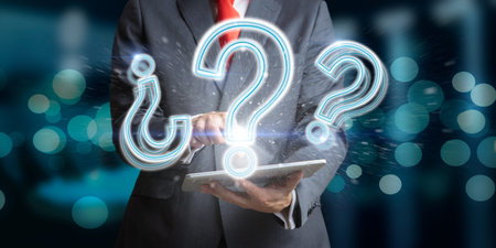 Businessman on a dark background with tablet and with question marks as a concept of doubt and...