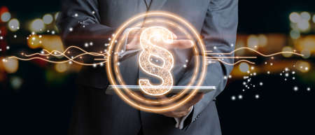 Businessman holding law paragraph. The icon of the balance of justice. Concept of legal advice, law and defense. Mixed mediaの写真素材