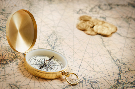 Compass on the old map with coinsの写真素材