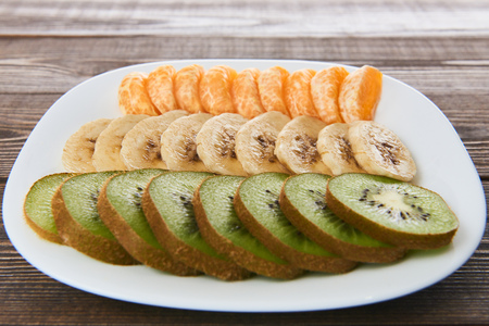 Slices of fresh fruit on a saucerの写真素材