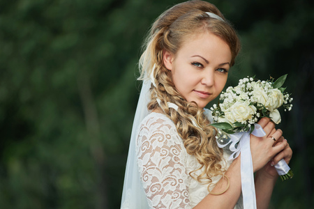 Young bride holding a bouquetの写真素材